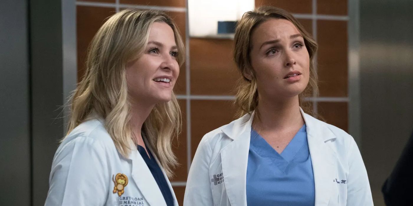 Jessica Capshaw smiling next to Camilla Luddington with a shocked expression in 'Grey's Anatomy' Season 14, Episode 9.