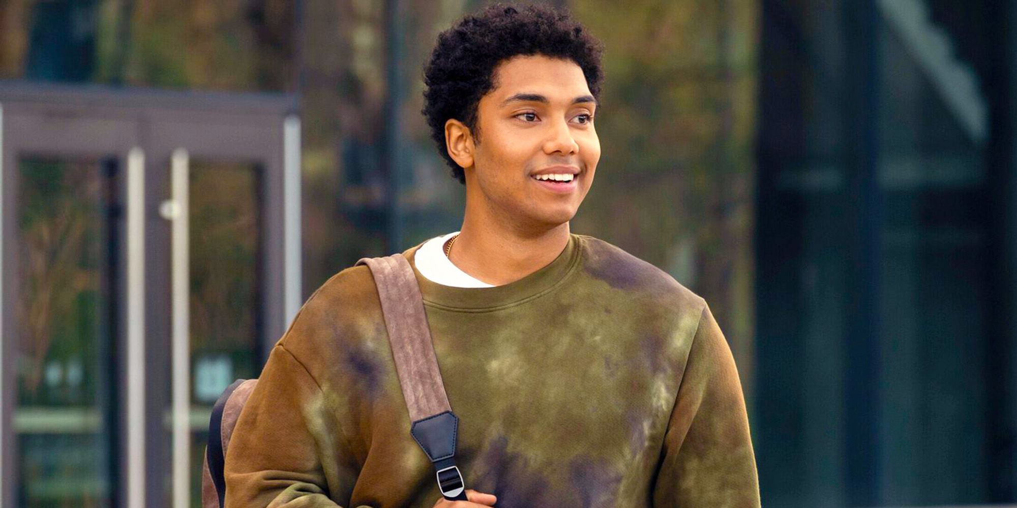 Chance Perdomo walking outside carrying a backpack in Gen V