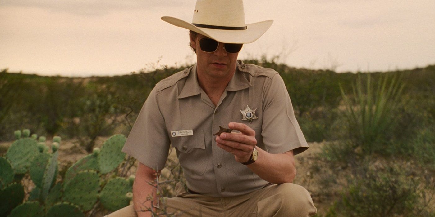 Chris Cooper as Sam Deeds looking at rusted sherriff's badge in Lone Star