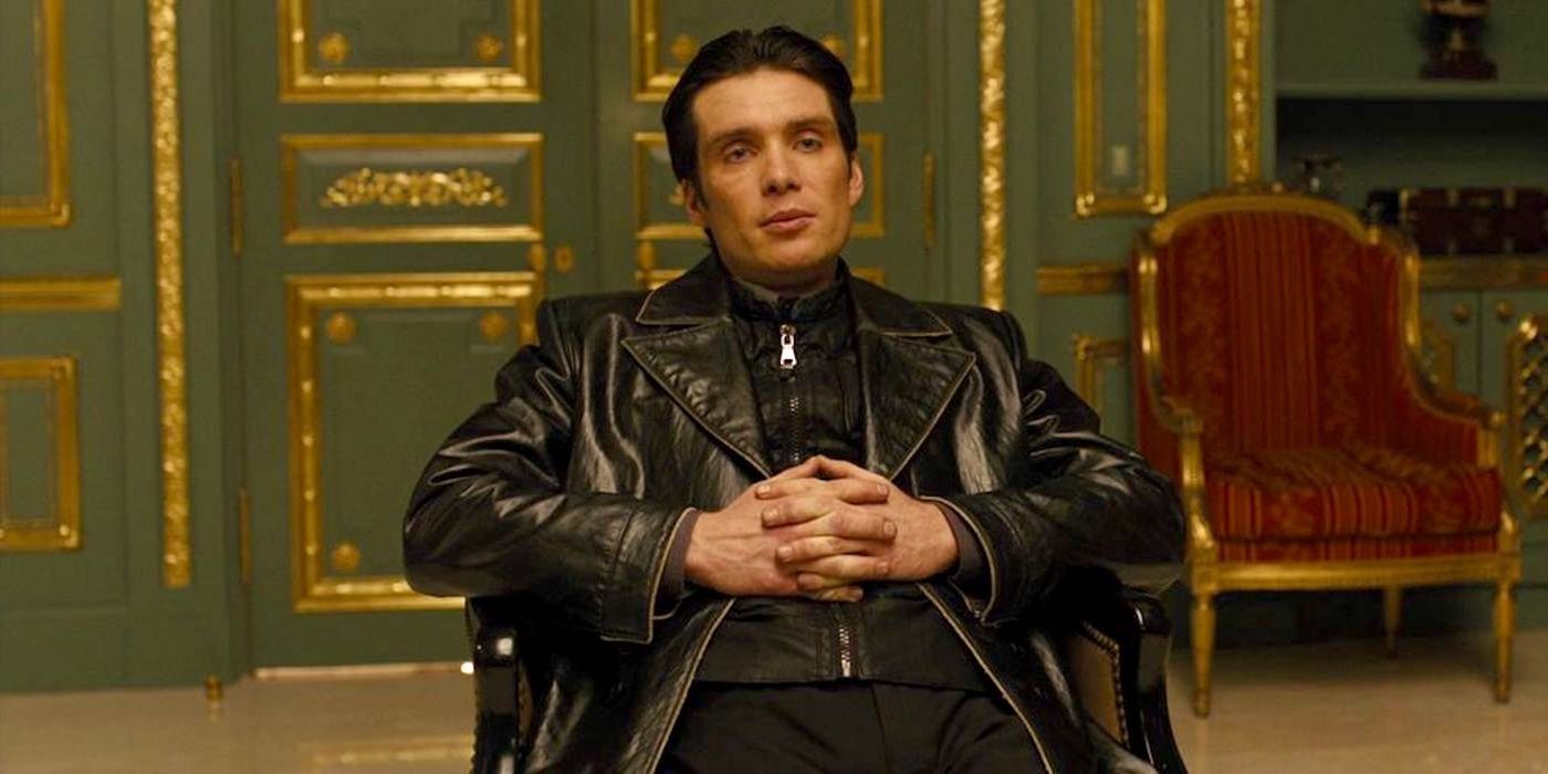 Cillian Murphy as Timekeeper Raymond Leon sitting with his fingers interlocked in In Time