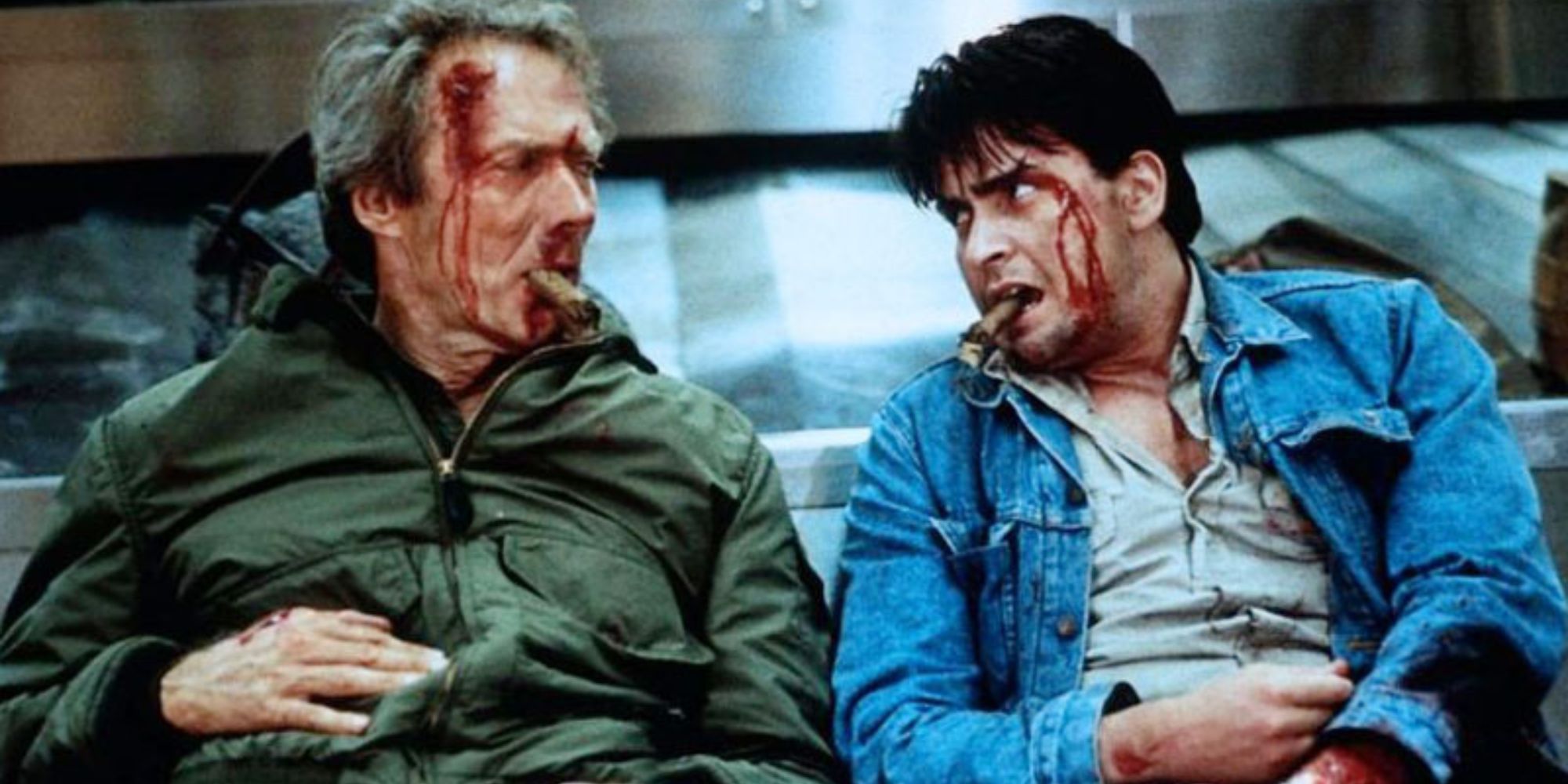 A bloodied Clint Eastwood and Charlie Sheen lean against an airport baggage carousel in The Rookie