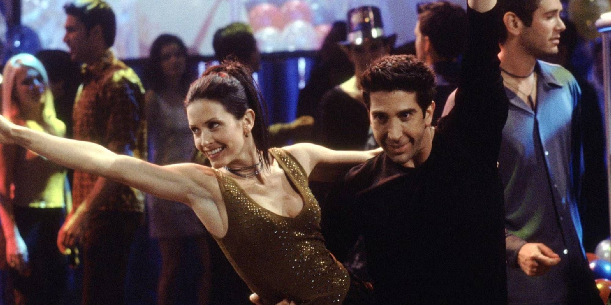 Courteney Cox and David Schwimmer as Monica and Ross dancing in Friends.