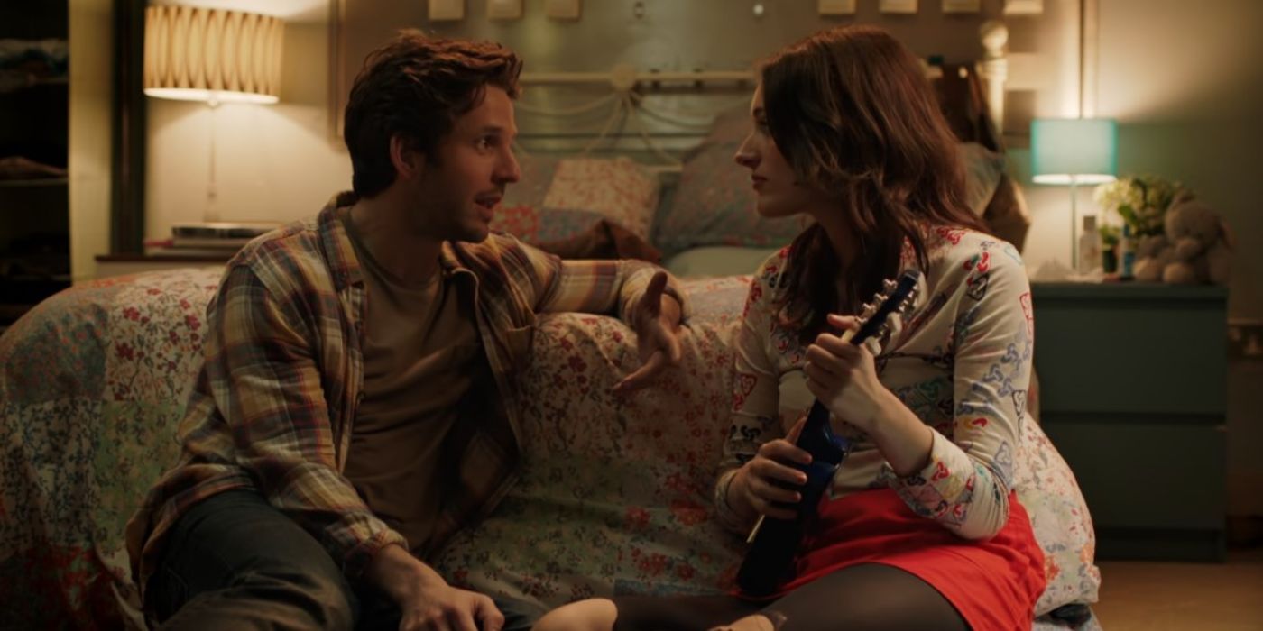 Anthony (Damien Molony) sitting across the floor from Lulu (Phoebe Waller-Bridge) holding a ukulele in 'Crashing'