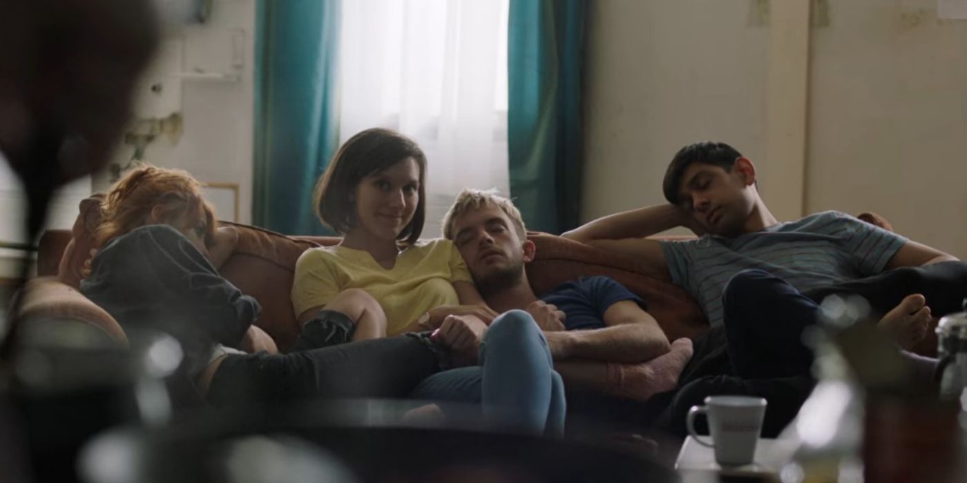 Jonathan Bailey as Sam in 'Crashing' sleeping on the couch with his other flatmates.