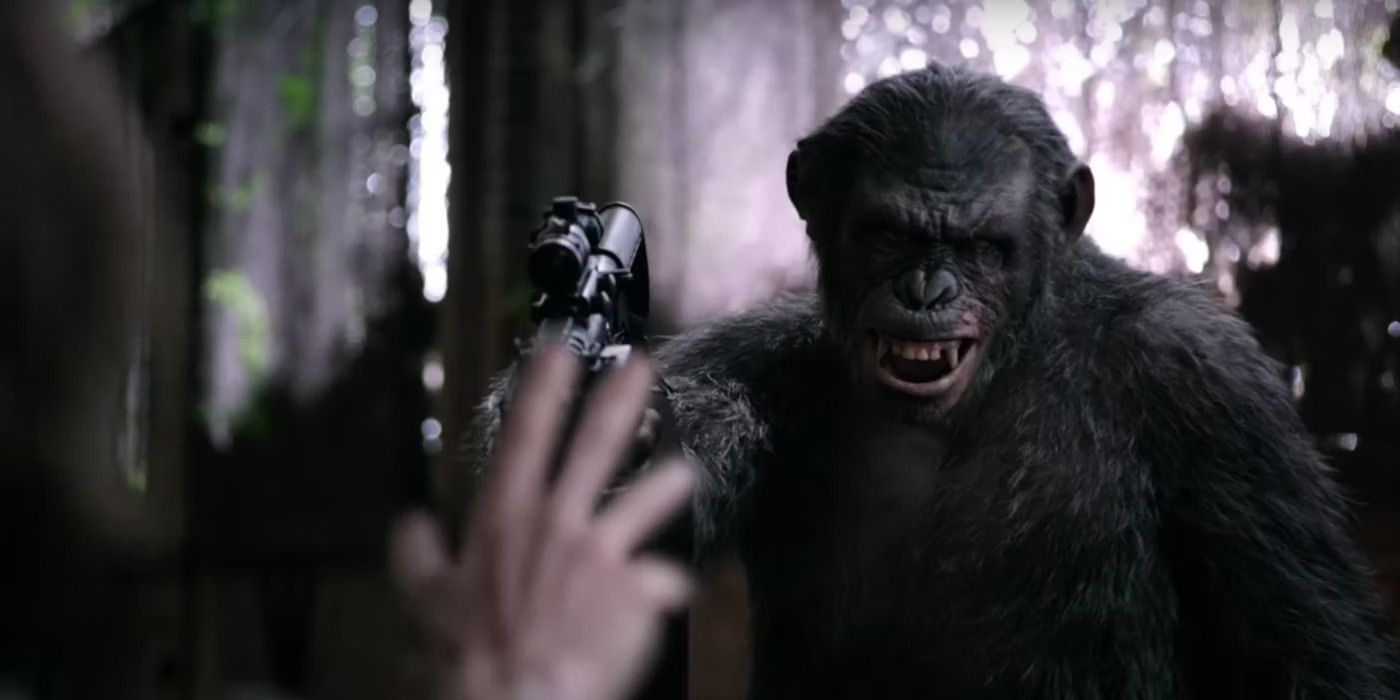 Koba gives a menacing look while pointing a gun at a person off screen in 'Dawn of the Planet of the Apes'