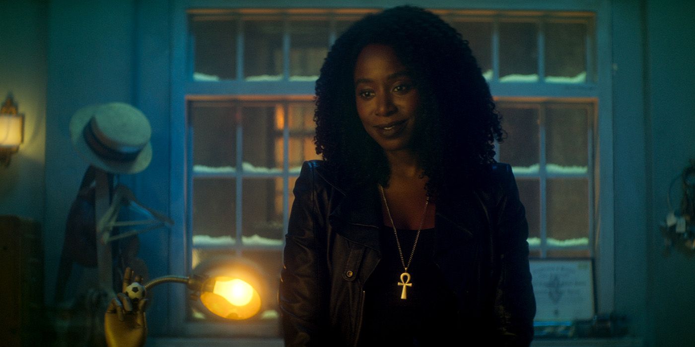 Kirby Howell-Baptiste as Death standing in front of a snowy window in Dead Boy Detectives 