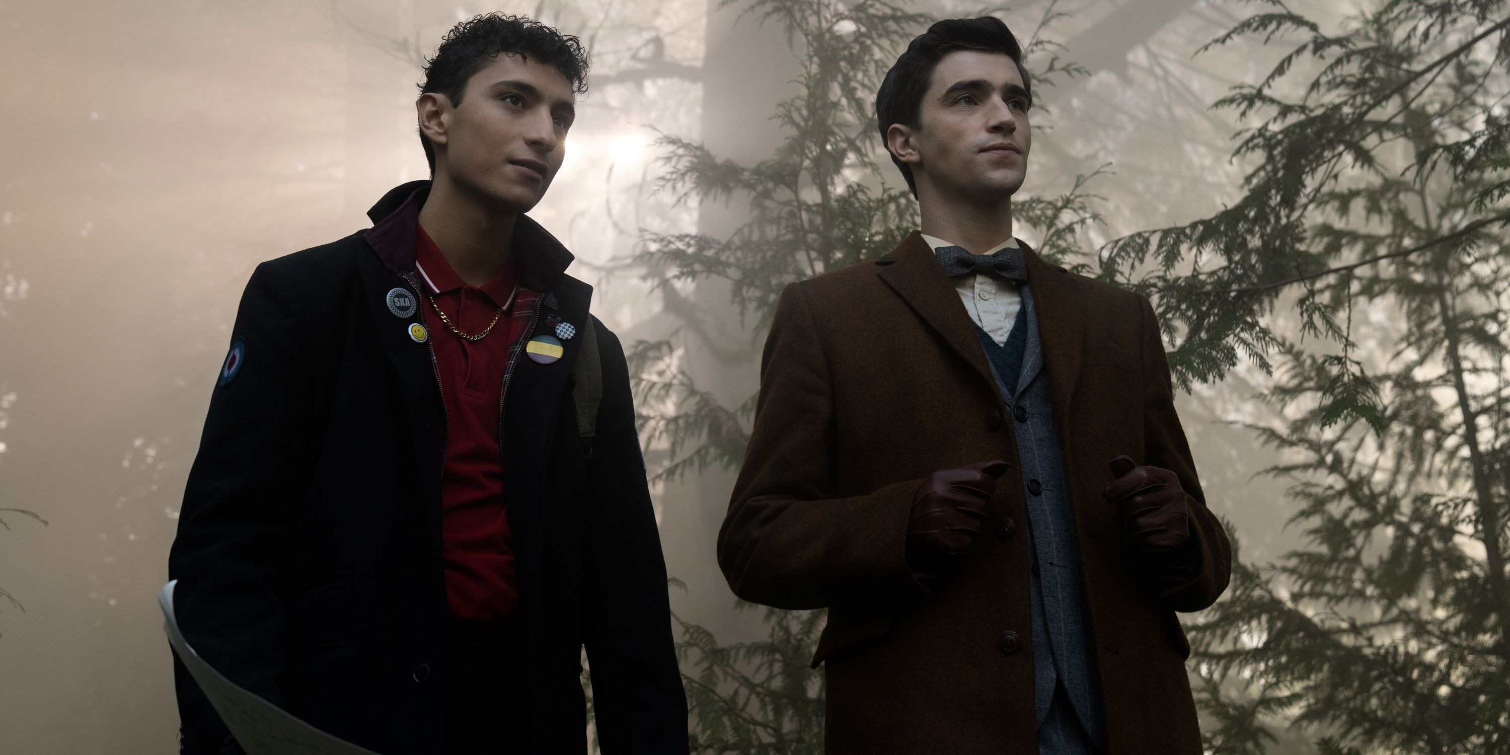 George Rexstrew as Edwin and Jayden Revri as Charles standing together in the forest in Dead Boy Detectives
