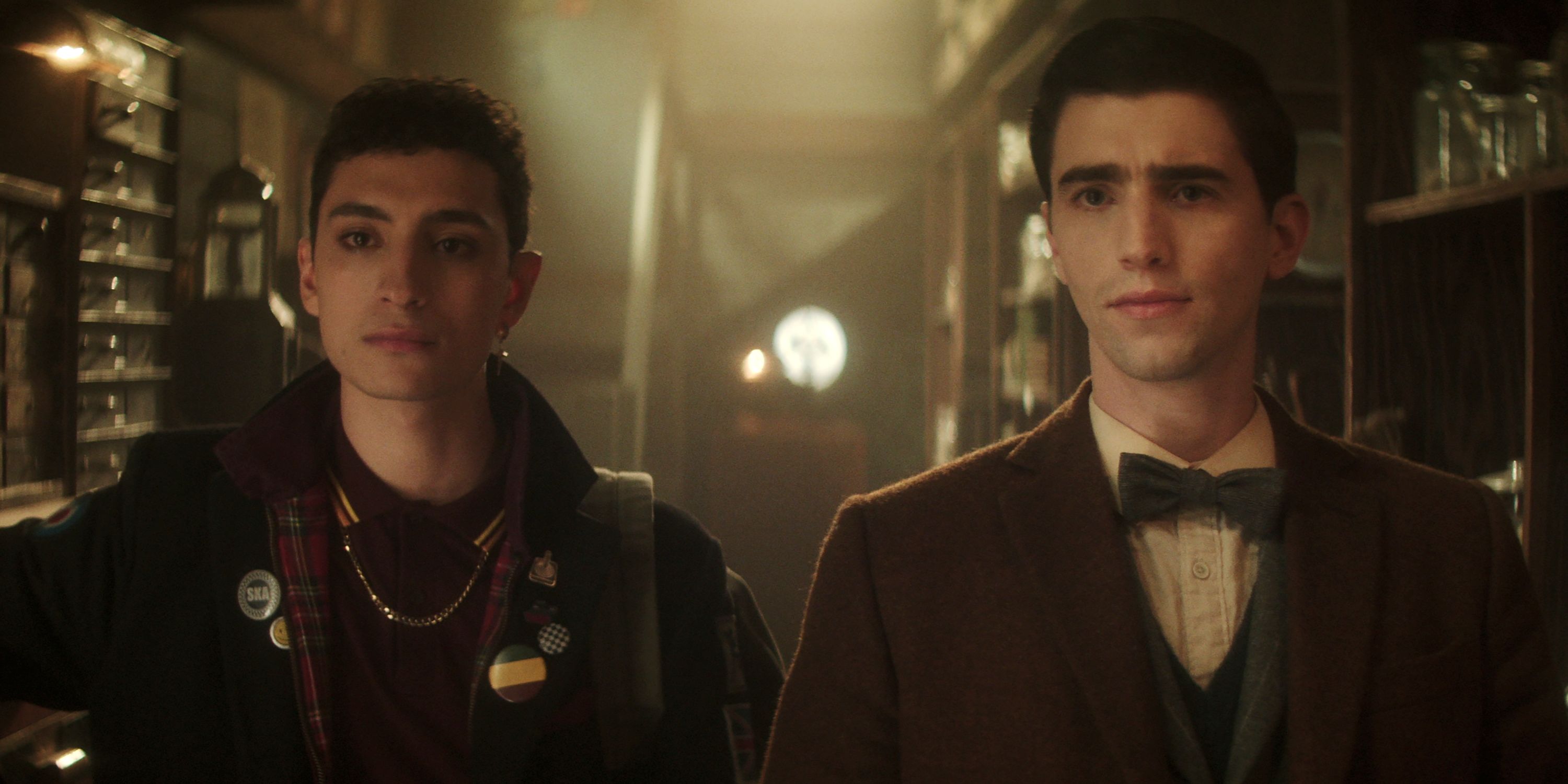 George Rexstrew as Edwin and Jayden Revri as Charles standing side by side in Episode 4 of Season 1 of Dead Boy Detectives