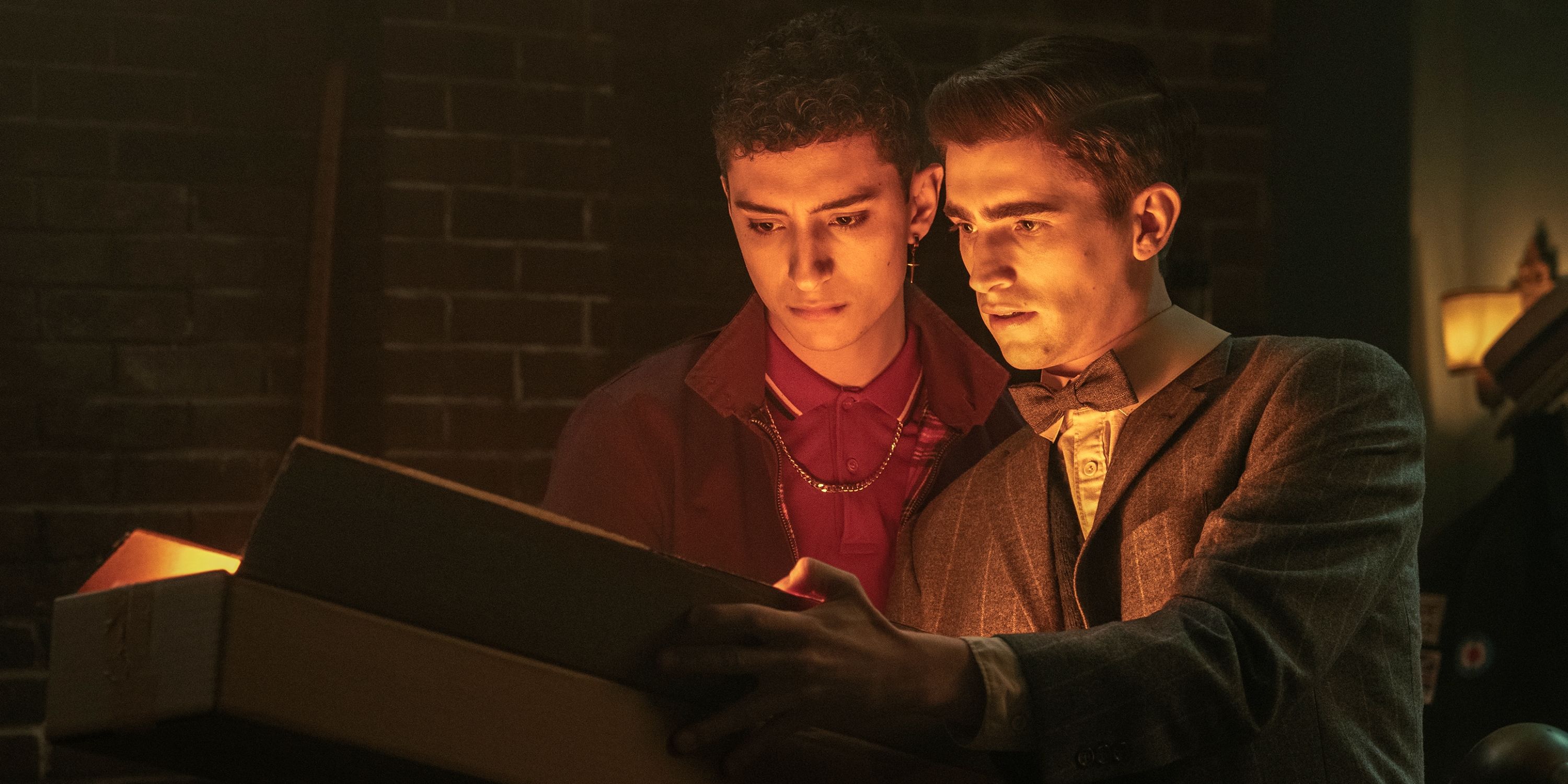 Edwin and Charles looking into a glowing box in Dead Boy Detectives