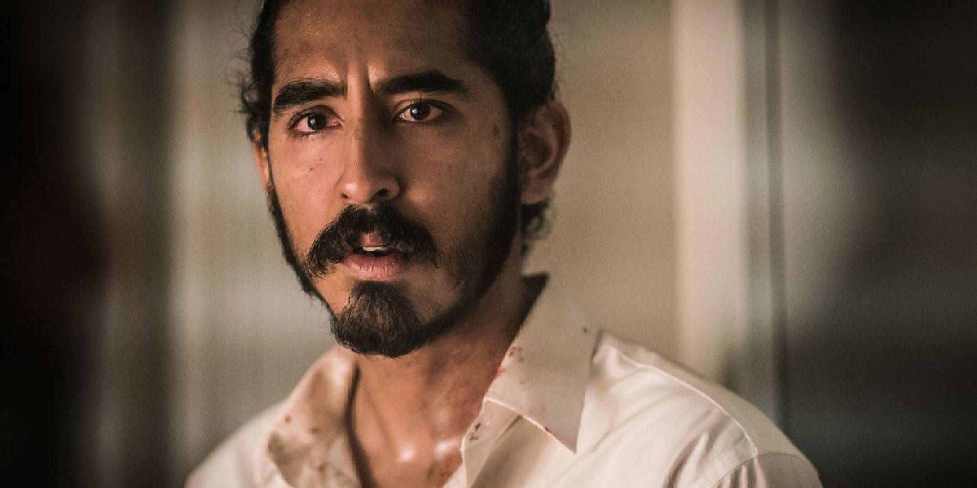 Dev Patel looking worried in a Hotel Mumbai close-up shot.