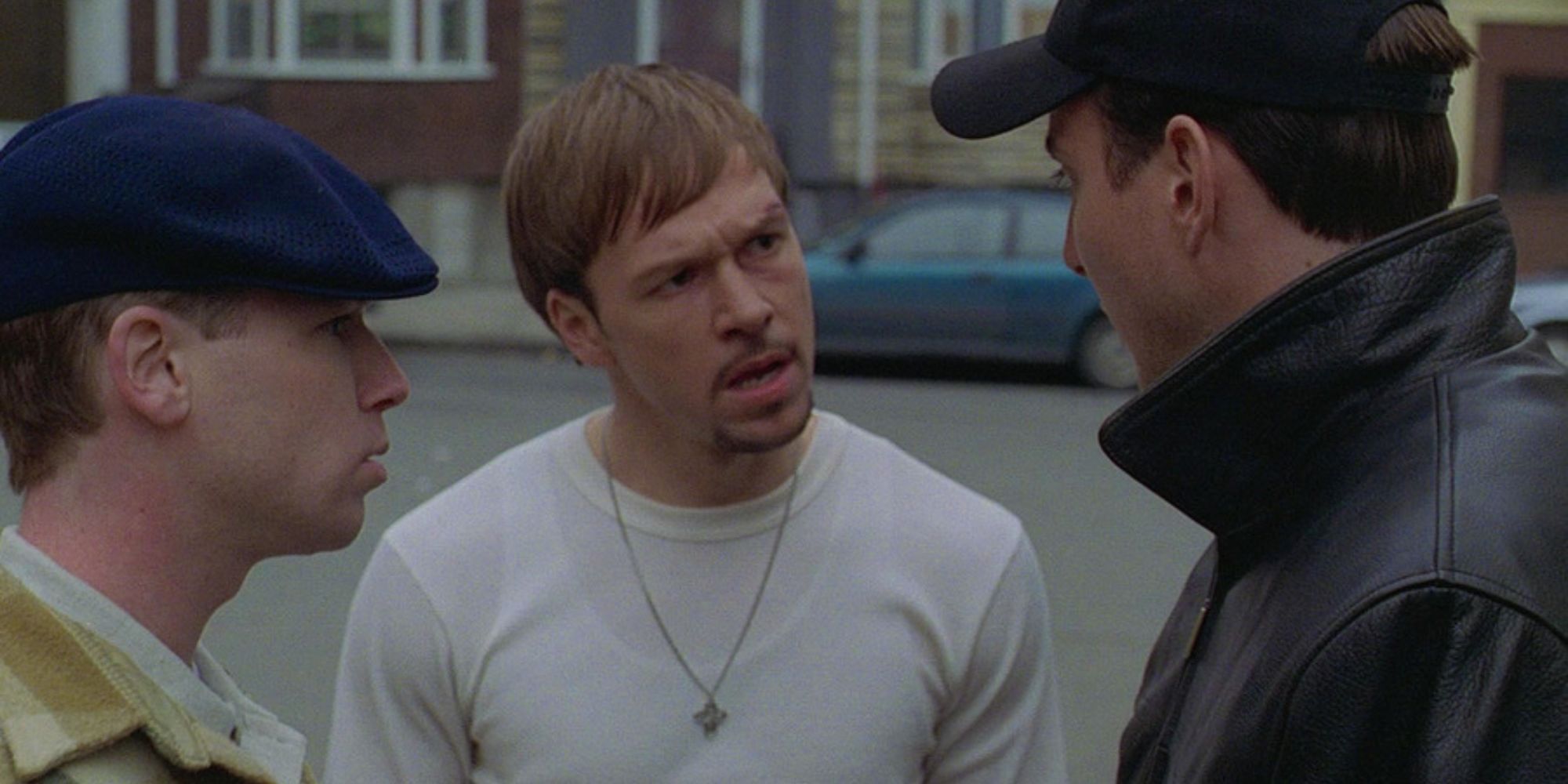 Donnie Wahlberg with two men on either side of him looks upset in Southie (1998)