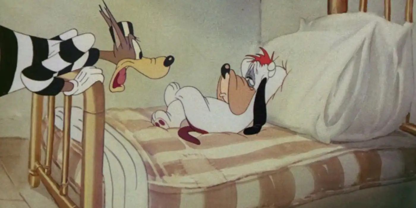 Droopy Dog lying in bed while Wolfie looks at him