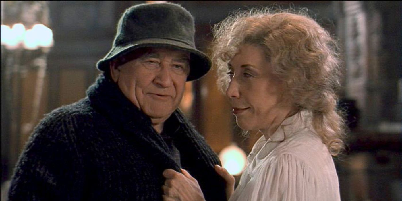 Ed Asner and Lily Tomlin stand facing each other affectionately from episode How the Ghosts Stole Christmas-in-The-X-Files