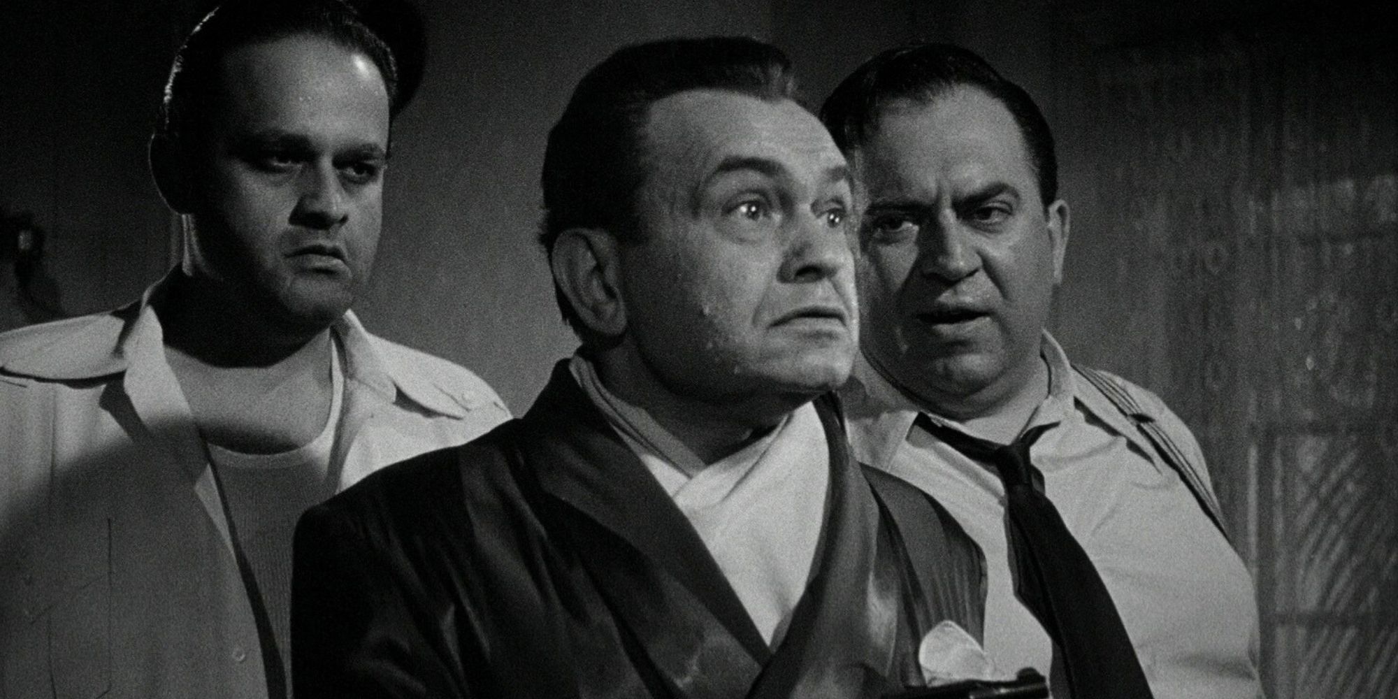Johnny Rocco standing with two men behind him in Key Largo (1948)