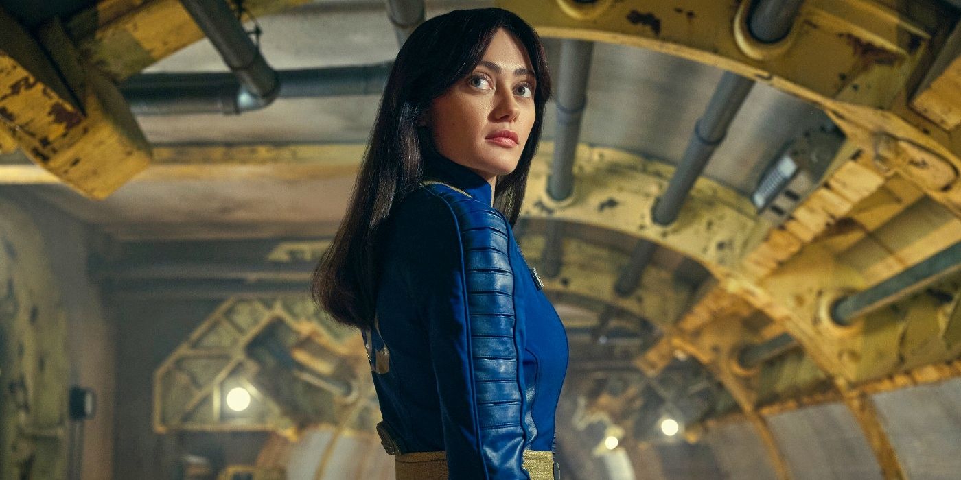Ella Purnell as Lucy standing in a Vault looking over her shoulder toward the camera in Fallout