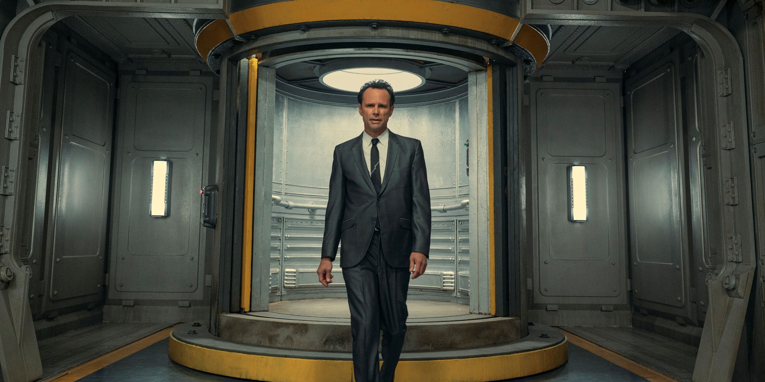 Walton Goggins as Cooper Howard walking down a valut hallway in Prime Video's Fallout