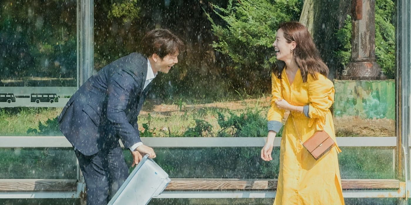 A couple laughing under the rain in Familiar Wife.