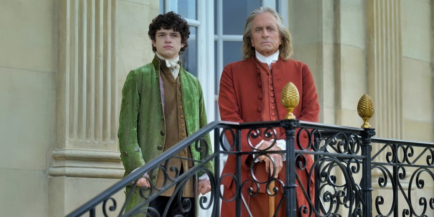 Noah Jupe and Michael Douglas stand on a balcony looking out, in Franklin Episode 4