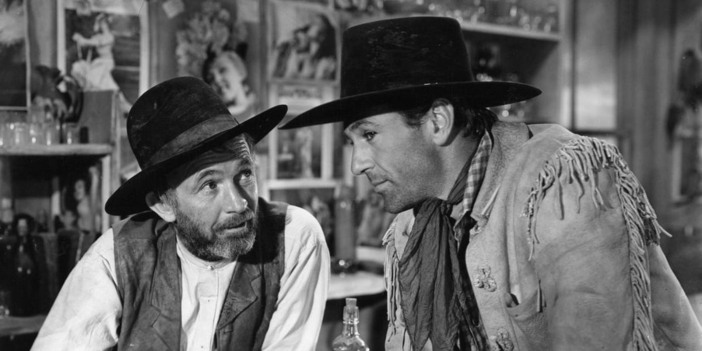 Gary Cooper as Cole Harden and Walter Brennan as Judge Roy Bean drink at the bar in 'The Westerner'