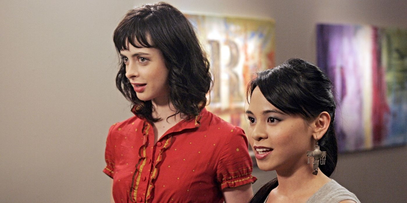 Krysten Ritter and Michelle Ongkingco as Lucy and Olivia, standing at an art show and smiling on Gilmore Girls