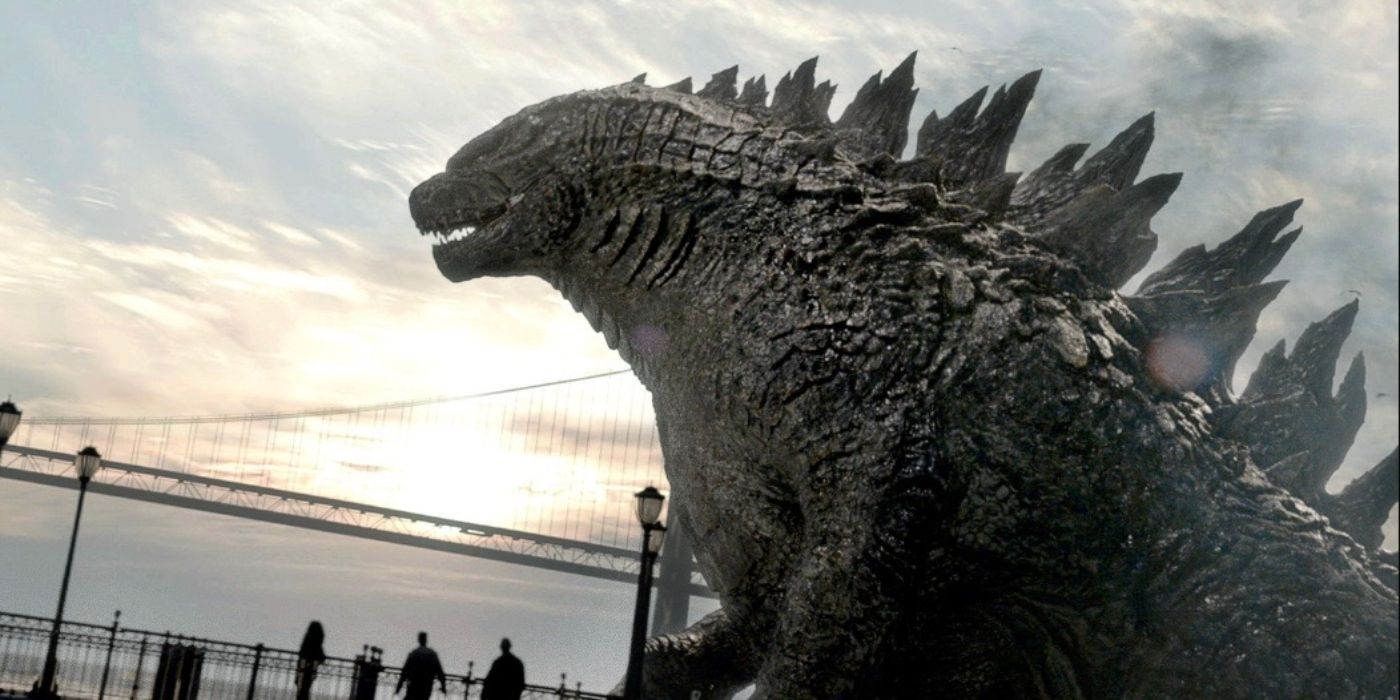 Godzilla standing over a bridge with people below him in Godzilla (2014)