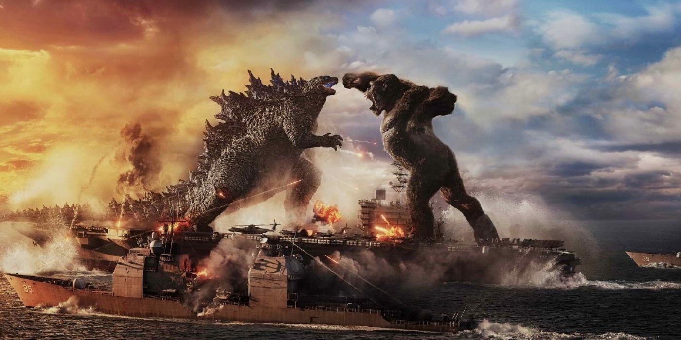 Godzilla and Kong standing on battleships in the ocean punching each other in Godzilla vs Kong (2021)
