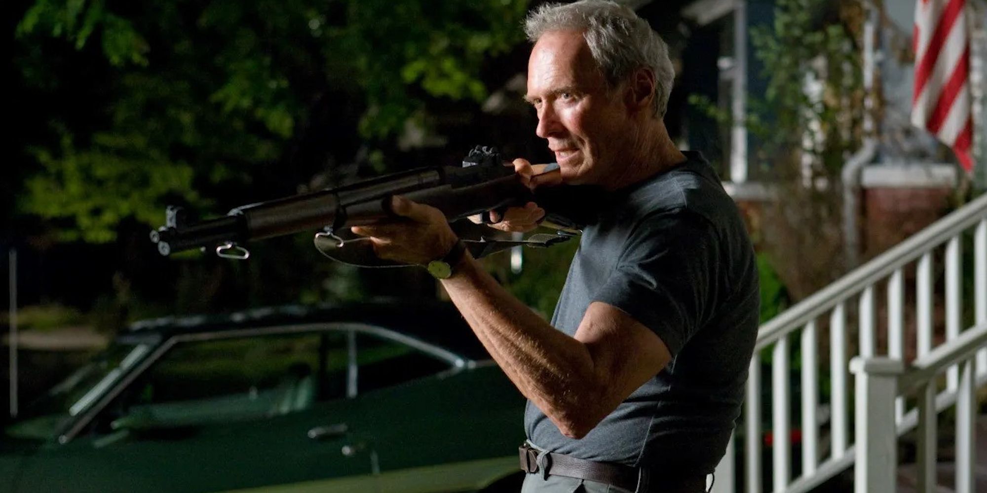 Walt Kowalski aiming a rifle at someone off-camera in Gran Torino