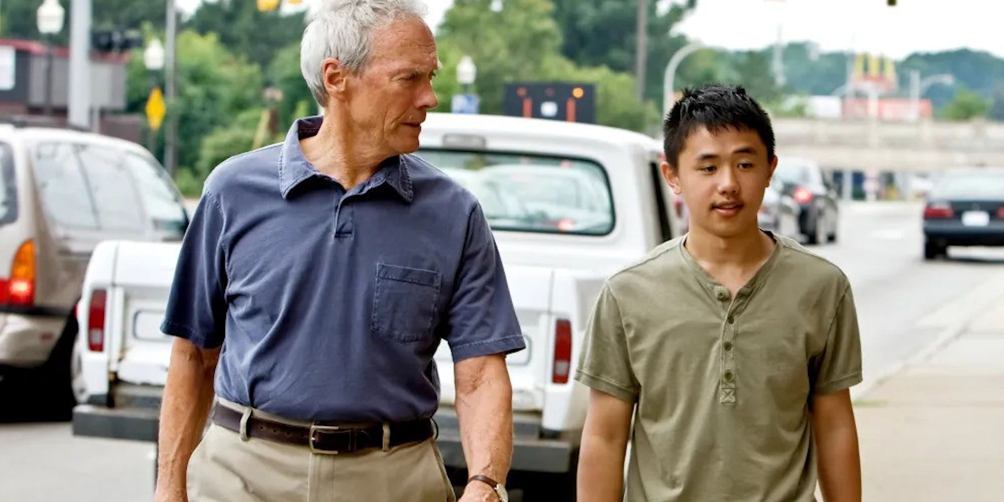 Clint Eastwood walking down the street with Bee Vang in Gran Tornio