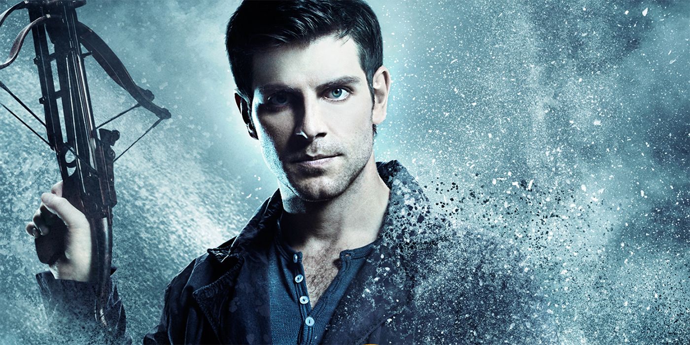 David Giuntoli holding a crossbow in a Grimm promo poster