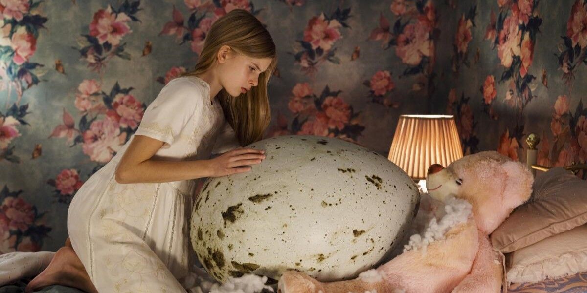 Tinja (Siiri Solalinna) touches a giant egg in Hatching