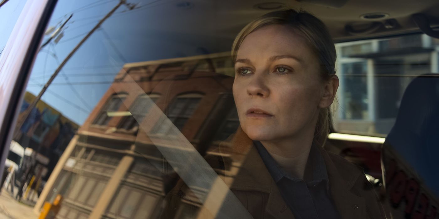 Kirsten Dunst as Lee Smith, staring out a car window, in Civil War.