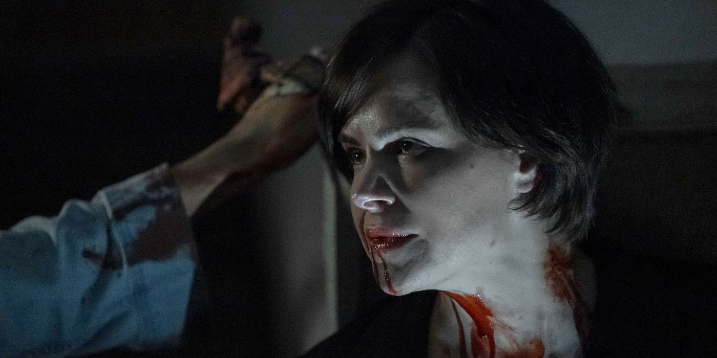 Emily Hampshire as Rachel York, looking serious while blood drips down her face and neck in Humane