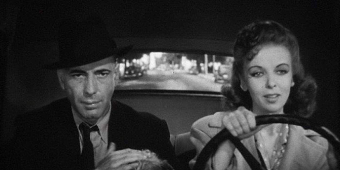 Humphrey Bogart as Roy Earle and Ida Lupino as Marie sitting in a car in 'High Sierra'
