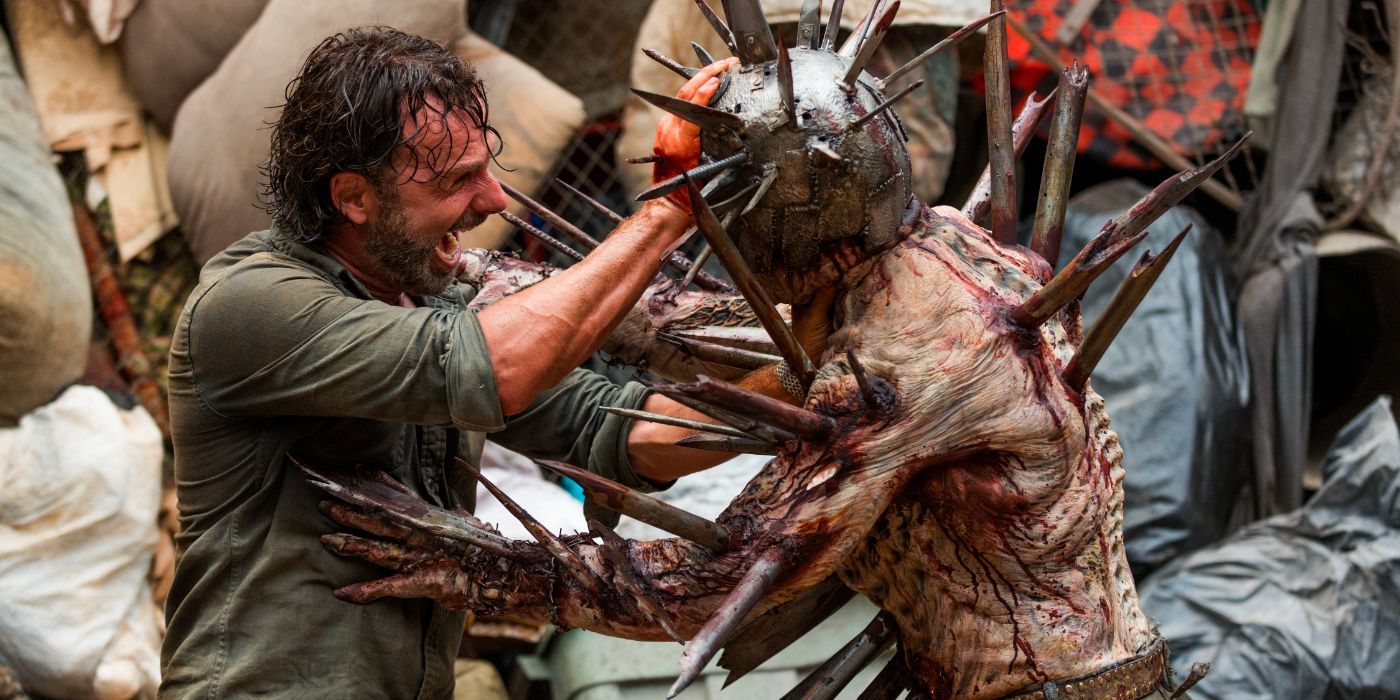 Andrew Lincoln as Rick Grimes fighting Jadis' armored and spiked walker in The Walking Dead.