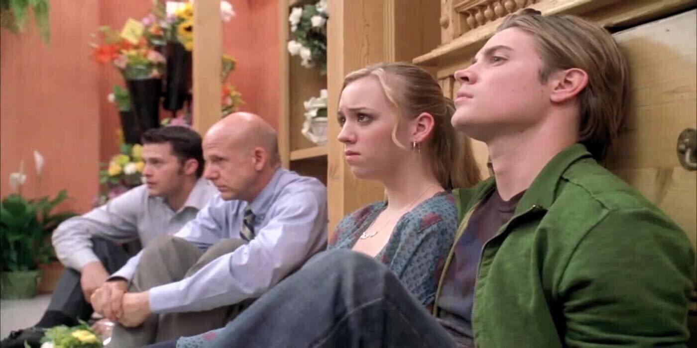 Julie and Austin sitting in a line next to two men. 