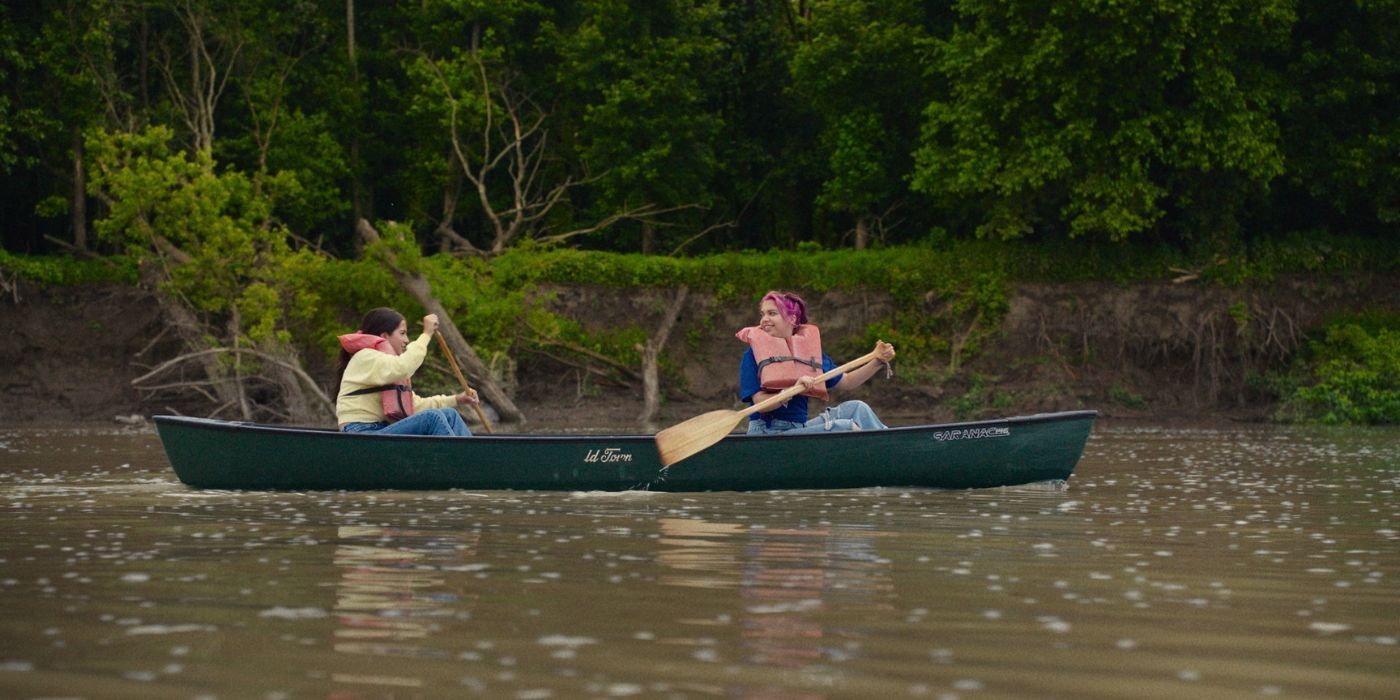 Isabela Merced and Cree as Aza and Daisy paddling down the White River in a green canoe in Turtles All the Way Down.