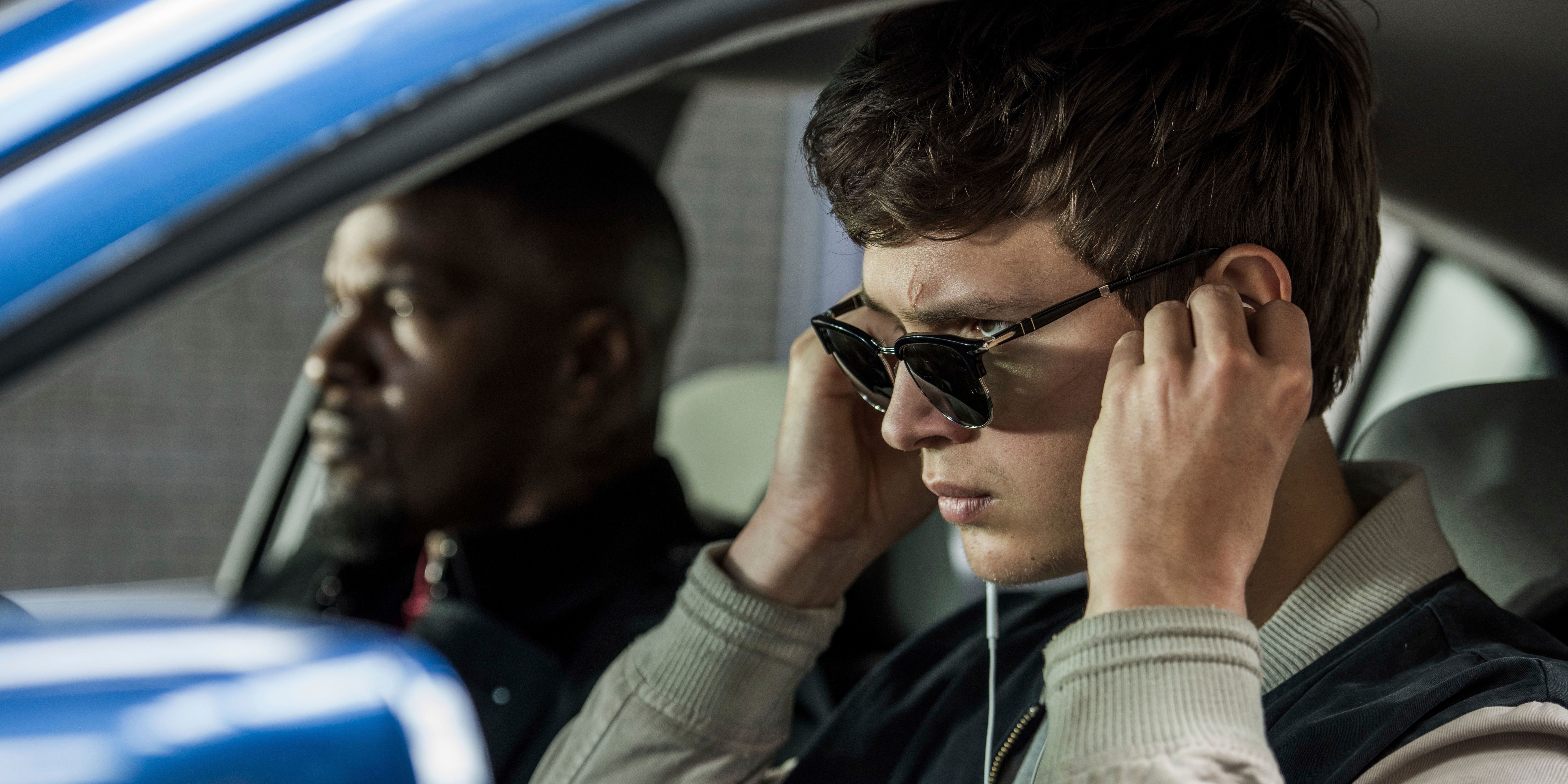 Ansel Elgort and Jamie Foxx sit in a car, while Elgort puts in wired ear-buds in Edgar Wright's 'Baby Driver'