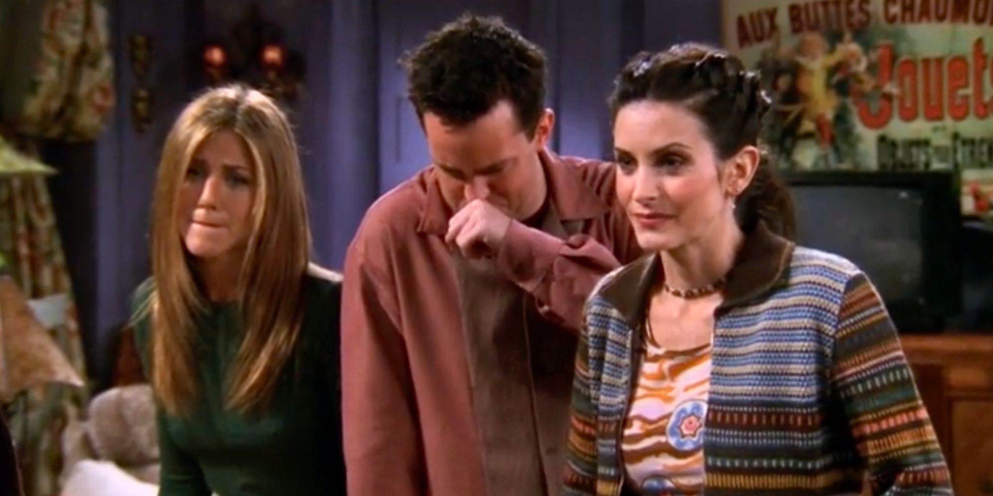 Rachel Green standing next to Chandler Bing trying not to laugh with Monica Geller standing on his other side in Friends