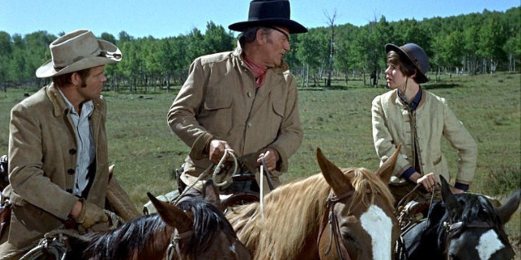John Wayne, Glen Campbell and Kim Darby all on horseback in True Grit (1969)
