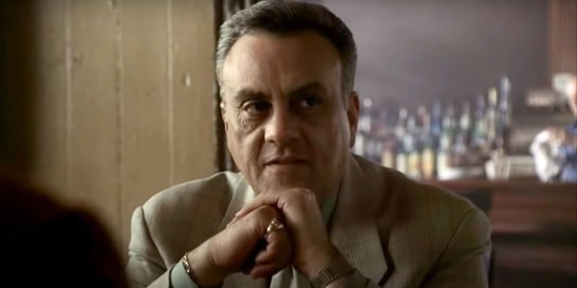 Vincent Curatola and Johnny Sack sitting and resting his chin on his closed fists in The Sopranos