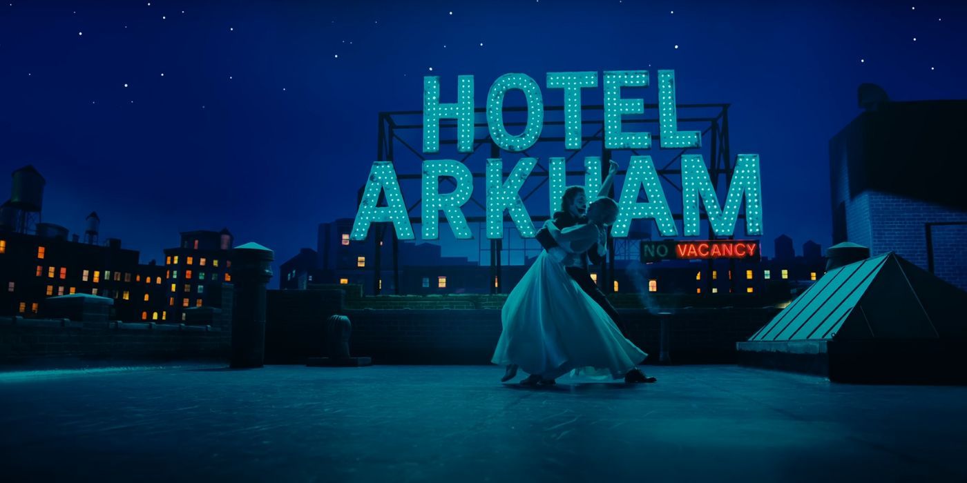 Joaquin Phoenix and Lady Gaga dancing on the rooftop of "Hotel Arkham" as Joker and Harley Quinn in Joker: Folie A Deux.