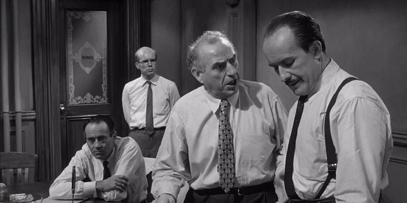 Jurors arguing in '12 Angry Men', Henry Fonda in the background, sitting down with a knife in front of him