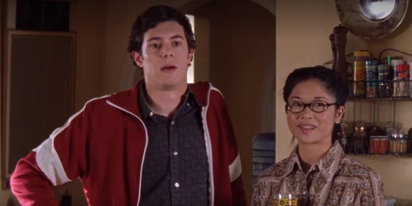 Adam Brody and Keiko Agena as Dave Rygalski and Lane Kim, standing in Lorelai&rsquo;s kitchen on Gilmore Girls