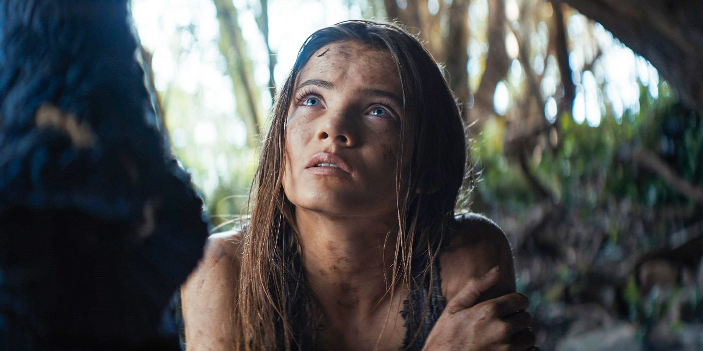 Freya Allan as Mae covered in dirt looks up cautiously in Kingdom of the Planet of the Apes
