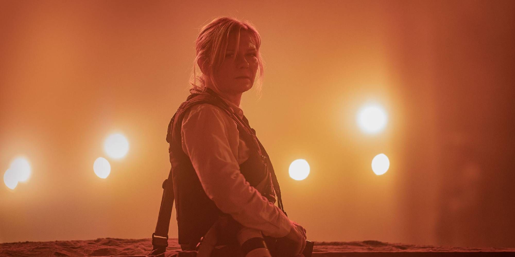 A foggy shot of Kirsten Dunst in Civil War staring into the camera.