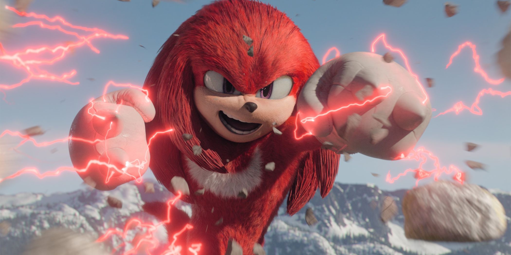 Knuckles surrounded by his red chaos energy, blasting through rocks with mountains in the background.
