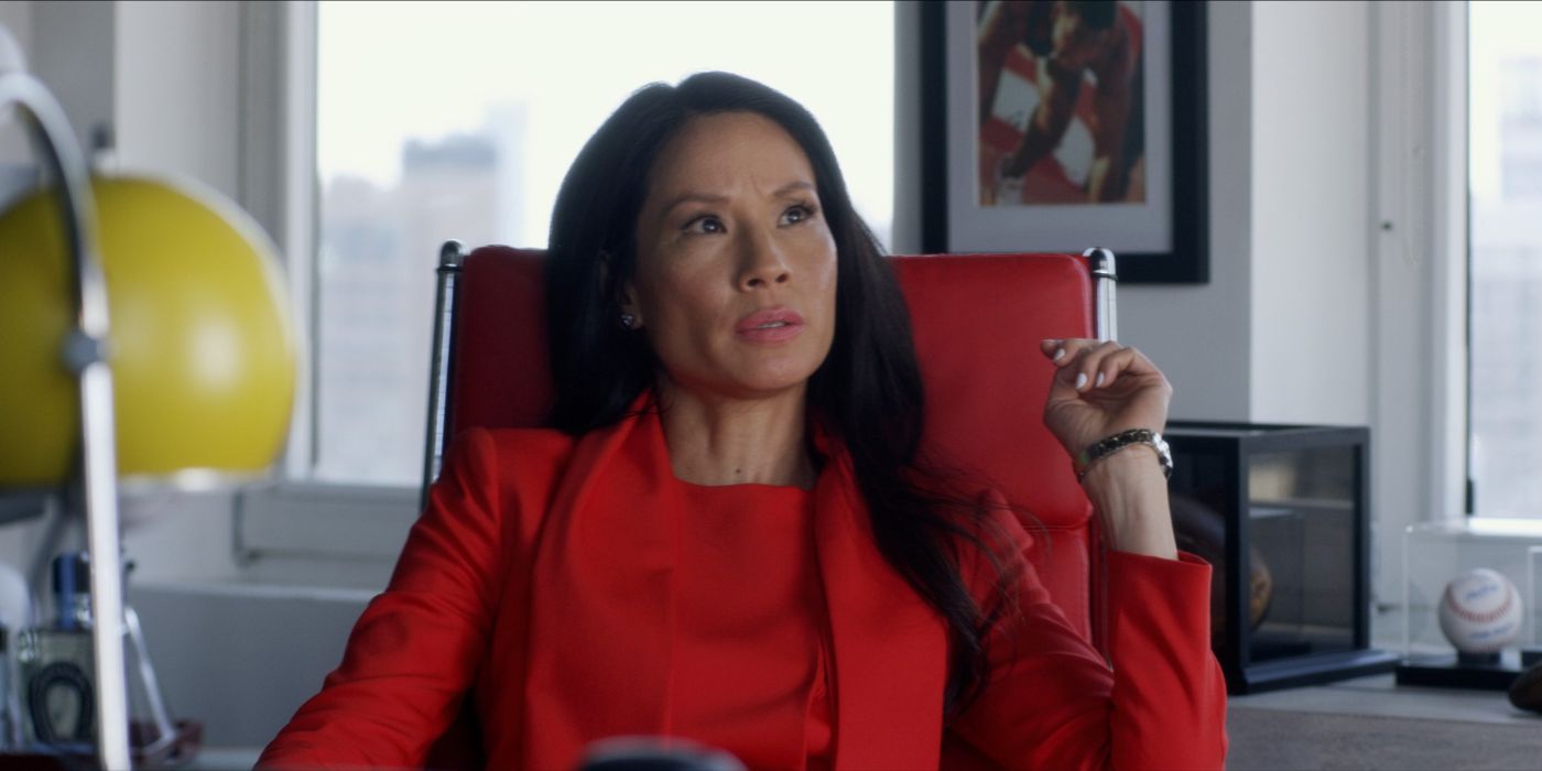 Lucy Liu sitting at her desk as Kirsten in Set It Up