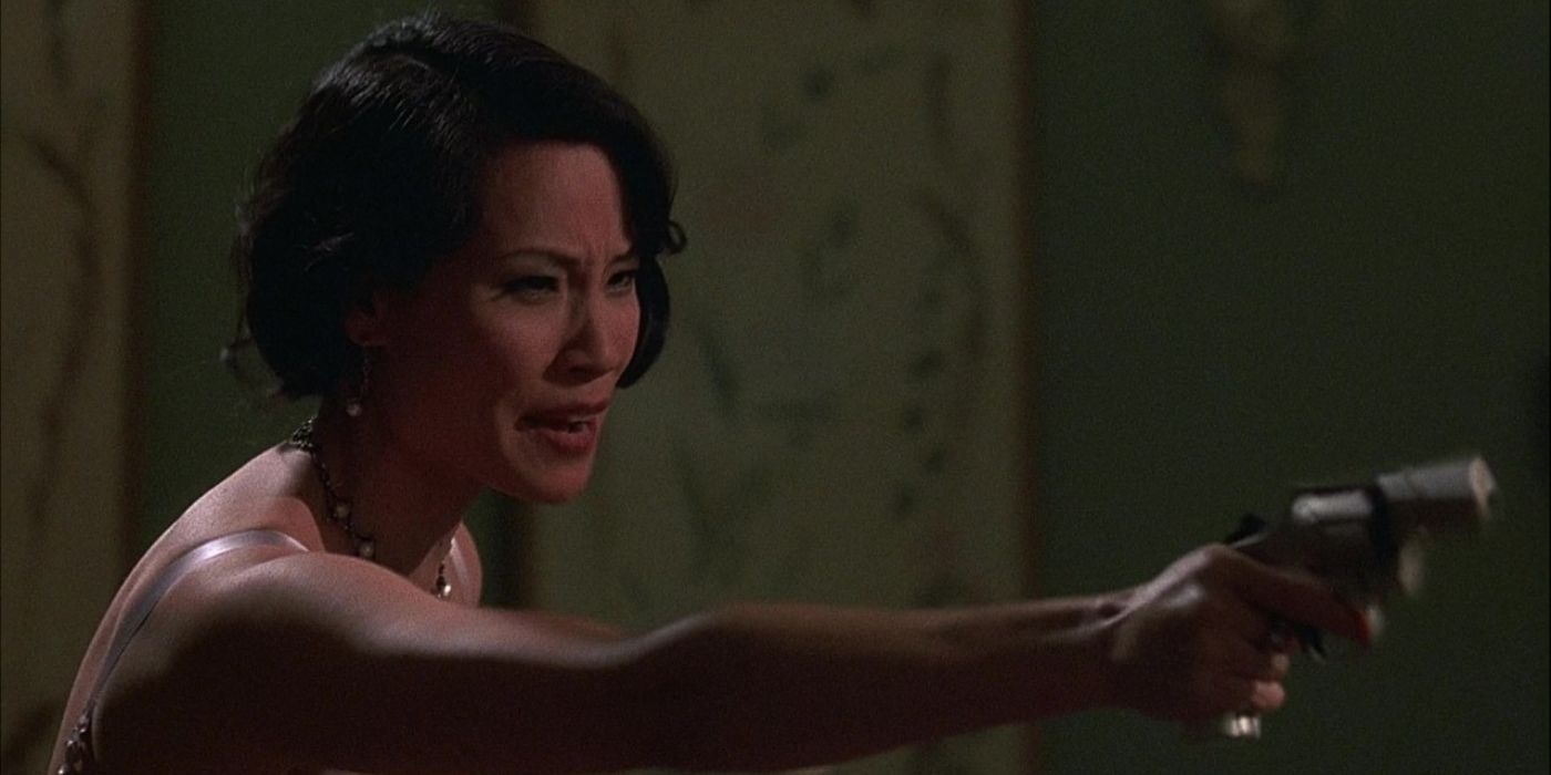 Lucy Liu pointing a gun as Kitty Baxter in Chicago