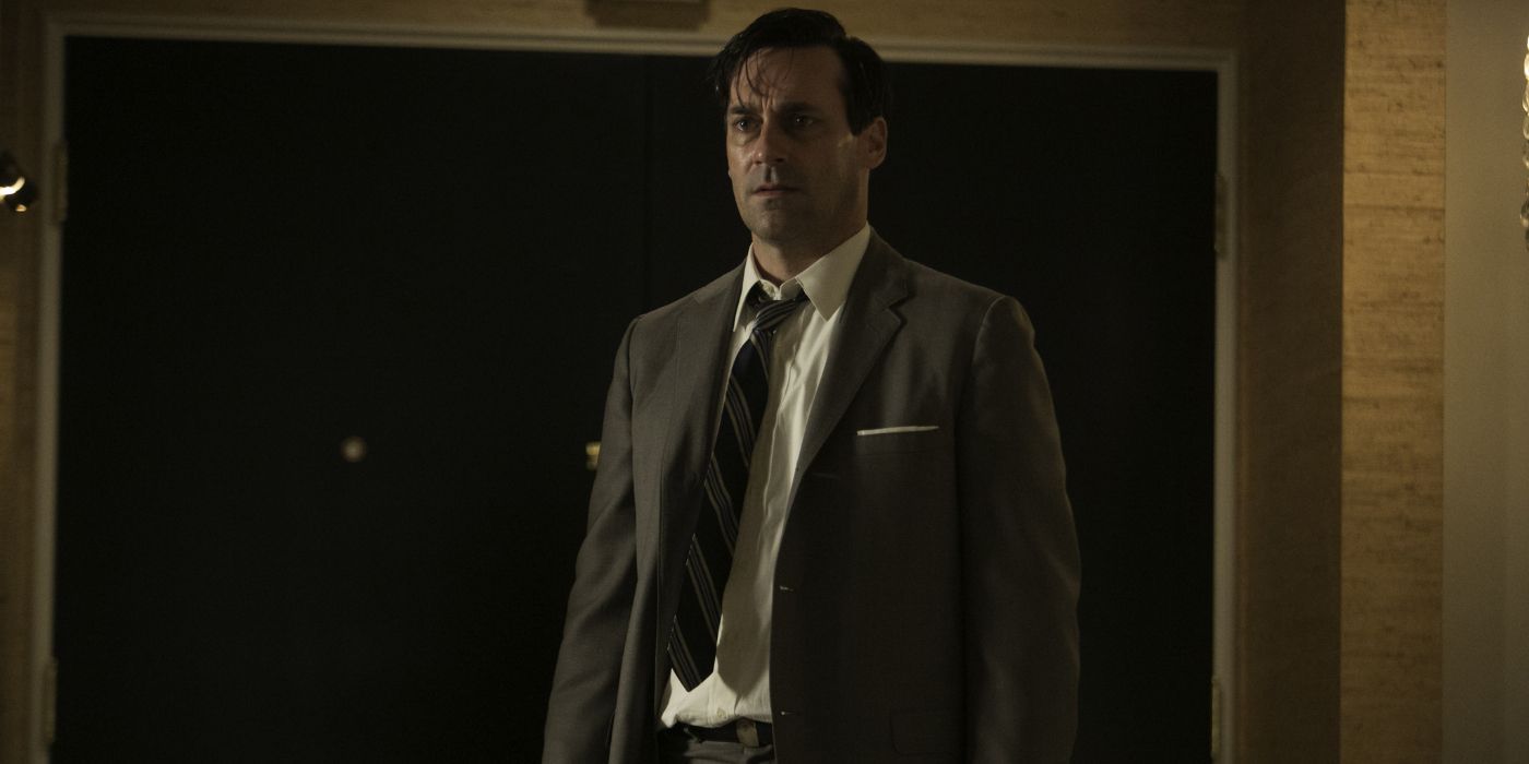 Don Draper (Jon Hamm) stands looking sweaty and run-down in a suit in 'Mad Men'