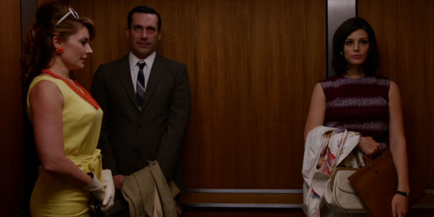 Don Draper (Jon Hamm) and Megan (Jessica Pare) stands awkwardly in an elevator with another woman in a yellow dress in 'Mad Men' Season 5, Episode 4 "Mystery Date" (2012)